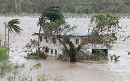 A bad year for Australia: a house partially submerged by flood waters in Queensland, February 3, 2011. Photo: Jamie Hanson / Newspix / Rex Features / telegraph.co.uk