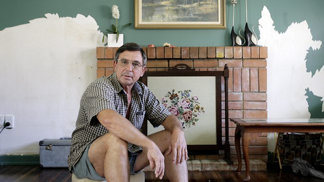 David Stark in his flood-affected home in the southern Brisbane suburb of Fairfield. Mr Stark, whose insurance claim has been rejected, is preparing a submission for the flood inquiry. Sarah Marshall