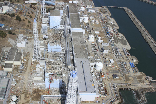 In this March 24, 2011 aerial photo taken by small unmanned drone and released by AIR PHOTO SERVICE, the crippled Fukushima Dai-ichi nuclear power plant is seen in Okumamachi, Fukushima prefecture, northern Japan. From top to bottom, Unit 1 through Unit 4. Air Photo Service Co. Ltd., Japan / cryptome.org