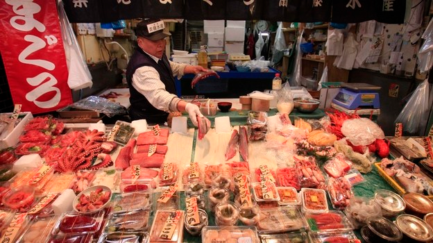A Tokyo tuna wholesaler adds slices of fish to his stall on March 23. Fish prices have plummeted in Japan amid fears that radioactive material leaking from the damaged Fukushima Dai-ichi nuclear power plant may have contaminated the animals. But experts say there's no risk right now and that fish is safe to eat. Lee Jin-man / AP
