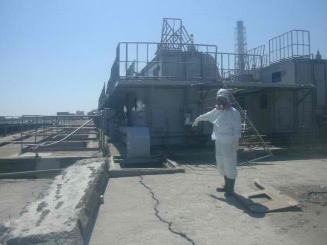 A worker points to a pit near the Fukushima No. 1 Nuclear Power Plant's No. 2 reactor from which radioactive water leaked into the Pacific Ocean. Photo courtesy of TEPCO