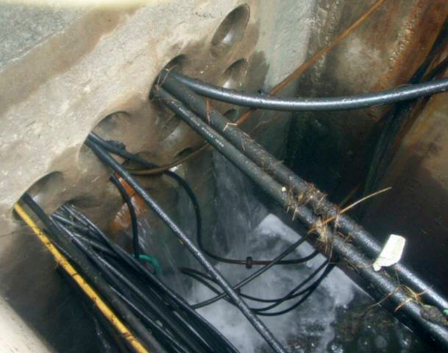 Water flows into a pit near the intake canal of Tokyo Electric Power Co.'s (TEPCO) Fukushima Daiichi Nuclear Power Station No.3 reactor, 12 May 2011. TEPCO / allvoices.com