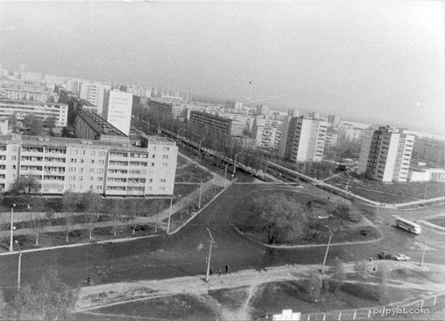 Pripyat, the 2nd day after the catastrophe. Pedestrians, a cyclist and automobiles can be seen on the photograph. The picture is made from helicopter at April, 27th, 1986 (the 2nd day after the accident). In 100 meters from cars (from the right on the way, where cars turn) there was a way of radioactive fallout (over the 'bridge of death'). The radiation level is 500 roentgens per hour. pripyat.com