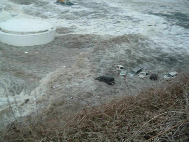 Tsunami wave washes away vehicles at the Fukushima Daiichi Nuclear Power Station, 11 March 2011. The location is the slope at the eastern side of Radioactive Solid Waste Storage Facility (The east side of Unit 5 taken from the southern side of the unit). TEPCO