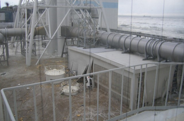 Tsunami wave inundates the Fukushima Daiichi Nuclear Power Station, 11 March 2011. The location is the north side of the Radiation Waste Treatment Facility, taken from 4th floor at approximately 3:44 PM. TEPCO