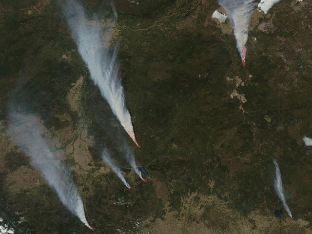 Satellite view of Slave Lake fire and many others in Alberta, Canada. The Moderate Resolution Imaging Spectroradiometer (MODIS) instrument that flies aboard NASA's Aqua satellite captured this visible image of fires (red areas) and smoke from the various fires raging on May 15, 2011 at 19:45 UTC (3:45 p.m. EDT). NASA image courtesy Jeff Schmaltz, MODIS Rapid Response Team at NASA Goddard Space Flight Center