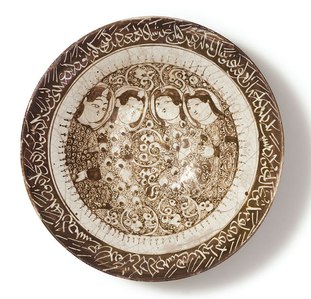 The four figures in this dish exemplify the 12th-century Seljuk-Persian aesthetic of 'moon-faced' beauty. Iran, Kashan. Early 13th century. Other/unnamed script. Courtesy of the Courtesy of the Nasser D Khalili Collection of Islamic Art.