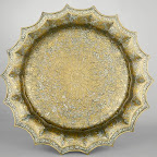 Large basins for ablution that have a crenellated rim are based on eastern Iranian prototypes of the late twelfth and early thirteenth centuries. The best examples, with lavishly inlaid and detailed decoration such as those shown here, seem to have been limited to the Ilkhanid period. Figural scenes illustrating courtly life under the Ilkhanids, indicated by their Mongol robes and headdresses, are common on these basins. Typically, the interior is lavishly ornamented whereas the exterior walls are plain or simply engraved, thus demonstrating that the decoration was enjoyed mostly when these basins were in use.