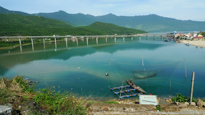 Top Gear fans: imagine this scene at sunset, and with Clarkson waxing lyrical over how the modern bridge and the old-fashioned boats sum up Vietnam for him. Look familiar? =)