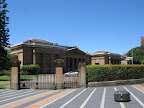 The courthouse next to the bus stop.