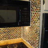 We took the backsplash up to the top of the cabinets on the walls that did not have any.