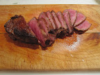 After the steak rested, I sliced it (and then sneaked a couple pieces for myself). Emerils Red Marble Steaks