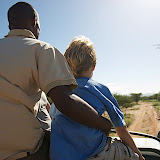 Pastor David and Avery riding on top of the truck, Korr, Kenya