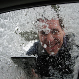 Dan scrapes ice from the windows