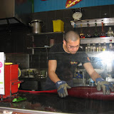 A candy artist demonstrates his craft for a small crowd.