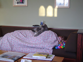 This is a cat lover: You can tell because she lets her cat sleep on top of her image of sleeping cat owner