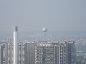 This balloon kept coming up behind the building and then dropping again