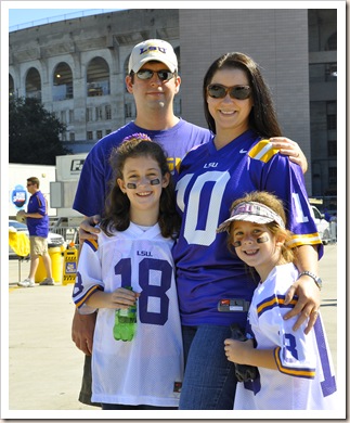 family in front of stadium