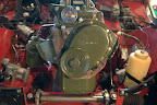 The renovated engine being put back into the car.