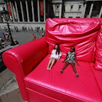 LONDON, ENGLAND - JULY 10: Two girls enjoy the sunshine from a giant pink sofa before the start of the finale of the T-Mobile Big Dance 2010 in Trafalgar Square on July 10, 2010 in London, England. Today's 'Big World Dance', involving thousands of dancers, is the climax of over 850 dance events that have taken place in the captial over the last 9 days. The T-Mobile Big Dance 2010, is London's Legacy Trust UK programme led by the Mayor of London in partnership with Arts Council England. (Photo by Peter Macdiarmid/Getty Images)