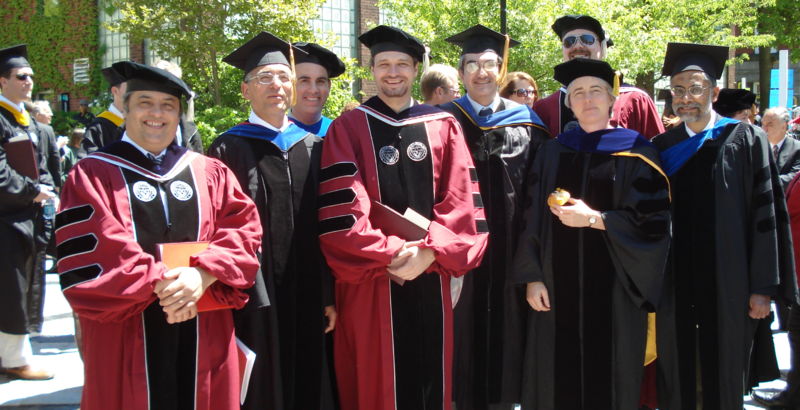 a group of people in academic regalia, with similar stripes on the sleeves