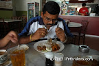 Muru digging into his nasi lemak