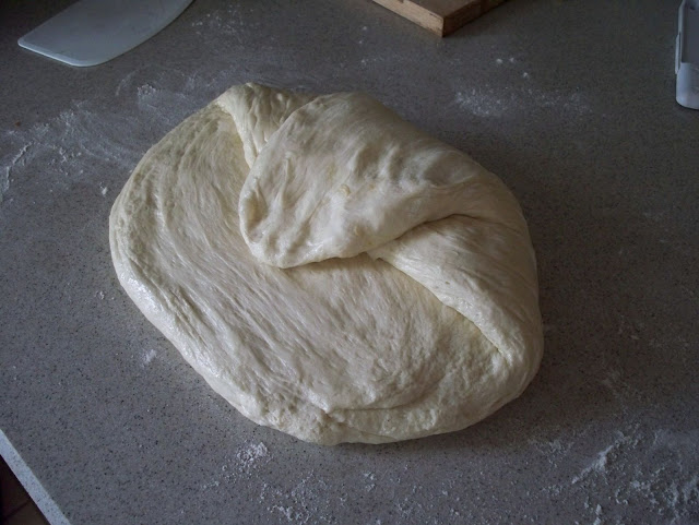 Fold the top of the loaf toward you, down toward the center of the dough