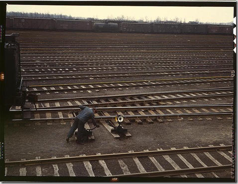 Switchman throwing a switch at Chicago and Northwest Railway Company's Proviso yard. Chicago, Illinois, April 1943. Reproduction from color slide. Photo by Jack Delano. Prints and Photographs Division, Library of Congress