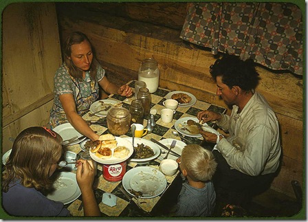 The Faro Caudill family eating dinner in their dugout. Pie Town, New Mexico, October 1940. Reproduction from color slide. Photo by Russell Lee. Prints and Photographs Division, Library of Congress