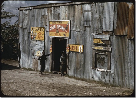 African American migratory workers by a "juke joint". Belle Glade, Florida, February 1941. Reproduction from color slide. Photo by Marion Post Wolcott. Prints and Photographs Division, Library of Congress