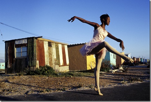 Ballet dancer strikes a pose outside her home in Khayelitsha, So