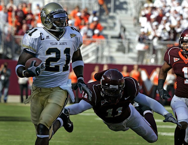 Virginia Tech Hokies football images wallpapers Georgia Tech wide receiver Calvin Johnson (21) runs is for a touchdown as Virginia Tech dfender Zavier Adibi (11) makes a last attempt for a tackle during first half action of the Georgia Tech-Va Tech Atlantic Coast Conference college football game at Lane stadium in Blacksburg, Va., Saturday Sept. 30, 2006.  (AP Photo/Steve Helber)