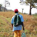  &ndash; Pa Foday makes his way to the clearing at the top of hill where the village is located. Dec. 2, 2007…. © 2007 NHA Photos