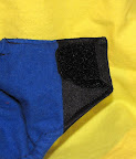 On the inside of each closure wing there is a small square of the soft half of the velcro.  This is so that you can fold the velcro closures over like so in the wash and will keep the diapers from hanging on to one another.