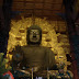 The Buddha. Following pictures are of this statue, two on each side and stone statues in the back of the building. Because it was dark I couldn't use flash so the pictures are rather shaky.