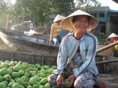 Floating market produce vendor in the Mekong River