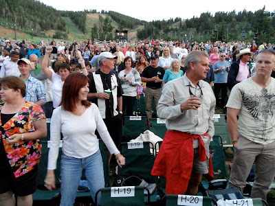 The crowd starts getting to their feet....