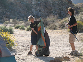 Kaiel sets up his tent.