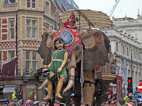 Longer view of the little girl and elephant