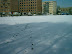 Walking through the snow to my apartment block in the background.