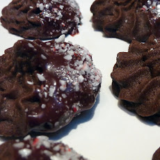 Chocolate Cookies Dipped in Chocolate-Cherry Sauce with Candy Cane Sprinkles