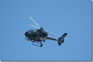 Police helicopter watches from the sky