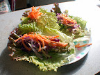 Red lettuce wraps filled with pate and topped with sprouted mung beans, purple cabbage, and shredded carrots