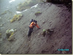 Harold carefully treading the sandy and steep slip, sometimes trying to gain balance.