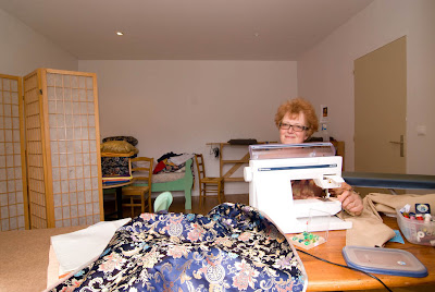 Lida sewing piles of brocades
