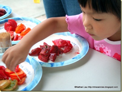 Esther tasting tomatoes