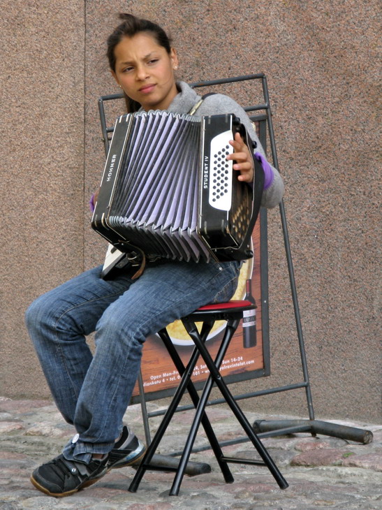 Gypsy girl plays accordion