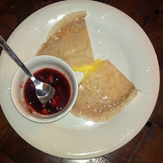 Tangerine Crepes With A Side Of Strawberry Reduction Sauce
