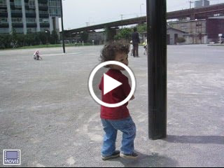 Eidan pretending to crash into posts, at the park adjacent to World City Towers in Shinagawa