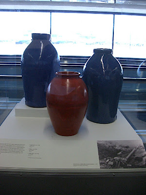 A large pair of Cobalt hand coiled oil jars and a Toyon Red Oil Jar stand guard at the beginning of the exhibit